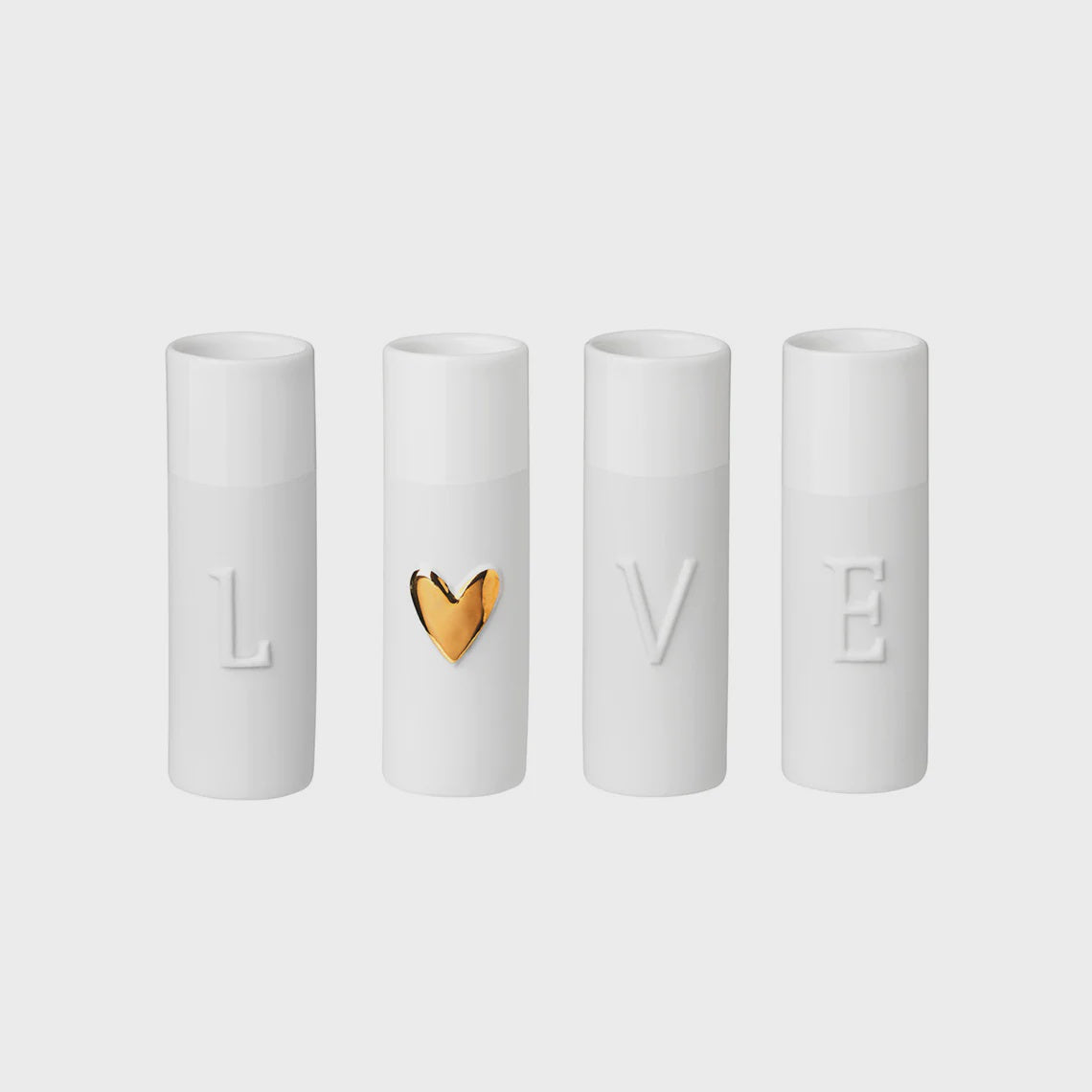 Four white cylindrical containers with 'LOVE' embossed on them, one featuring a gold heart.
