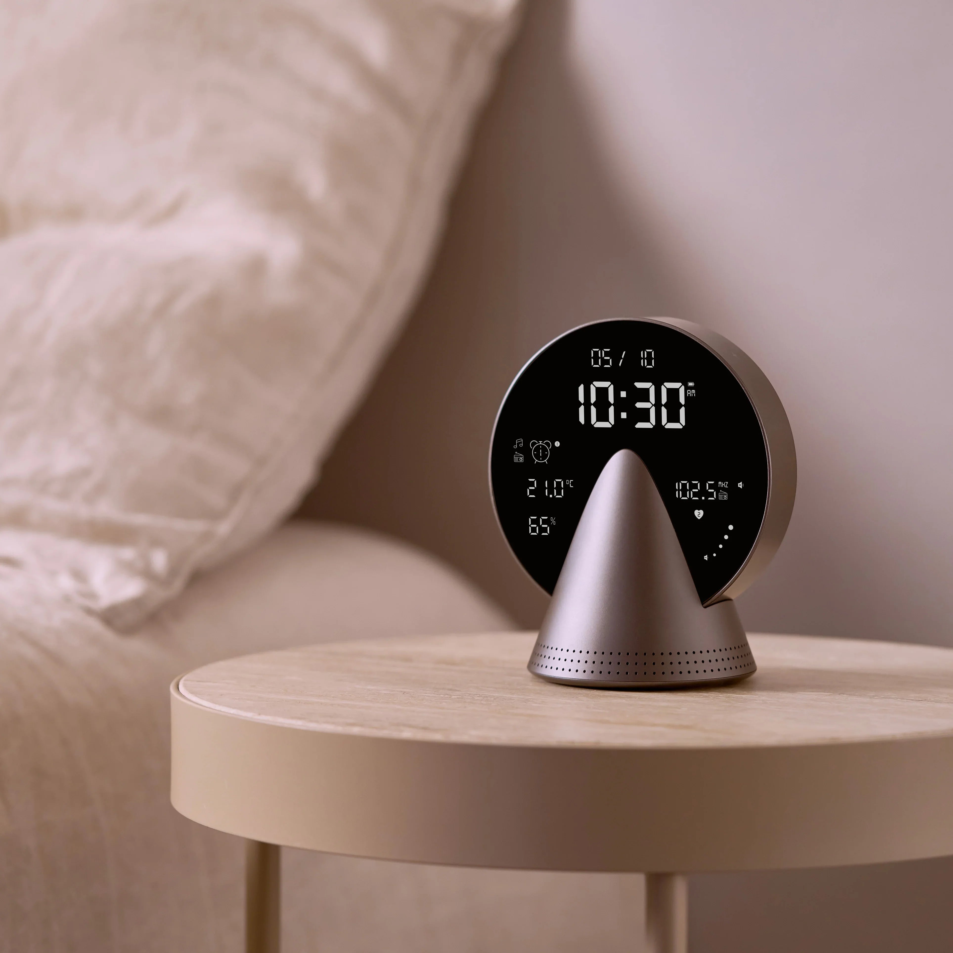 A Lexon alarm clock radio sitting on a bedside table