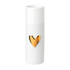 White vase with a gold heart-shaped design on a white background