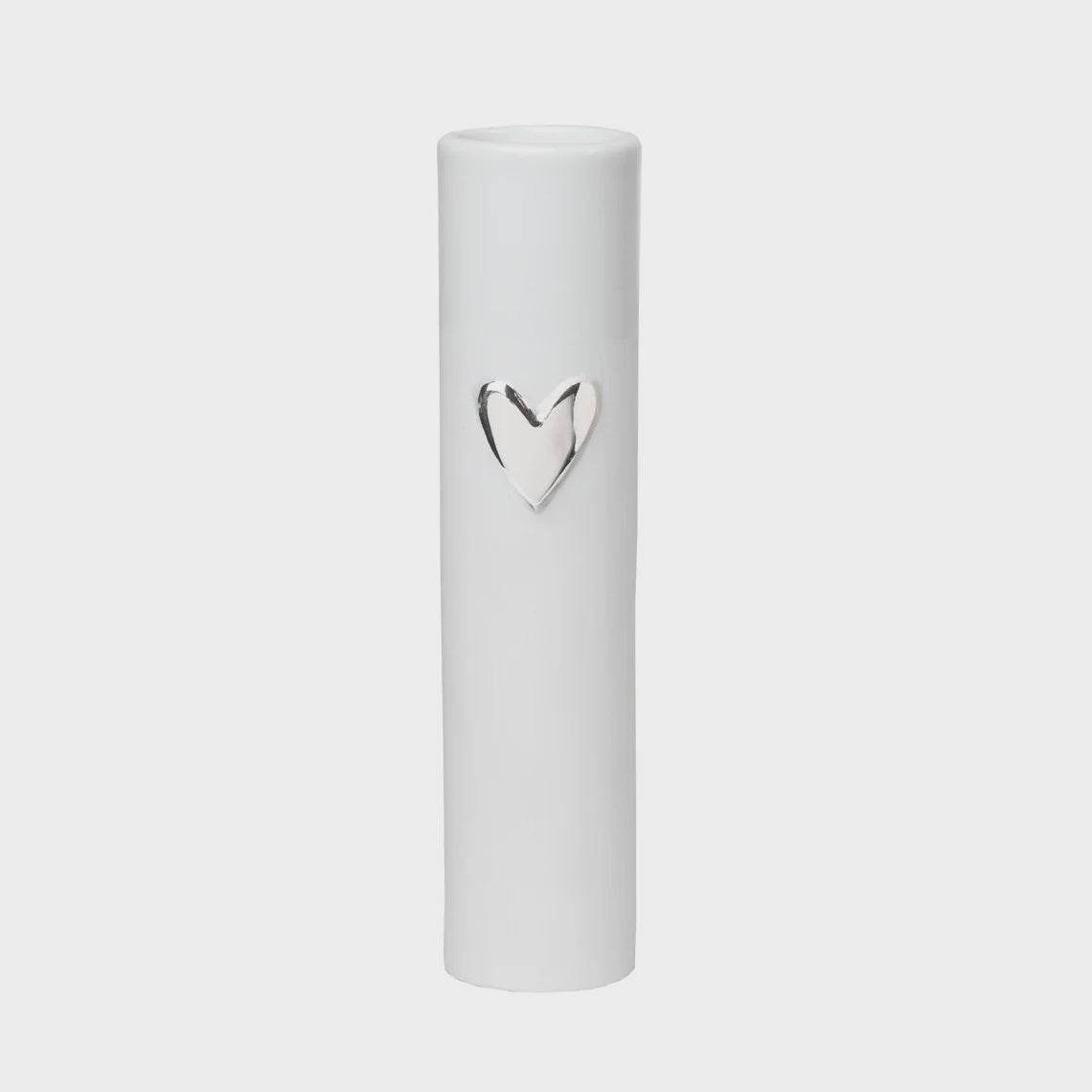 White cylindrical container with a silver heart-shaped emblem on a light gray background