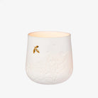 White ceramic candle holder with embossed design and gold dragonfly on a white background